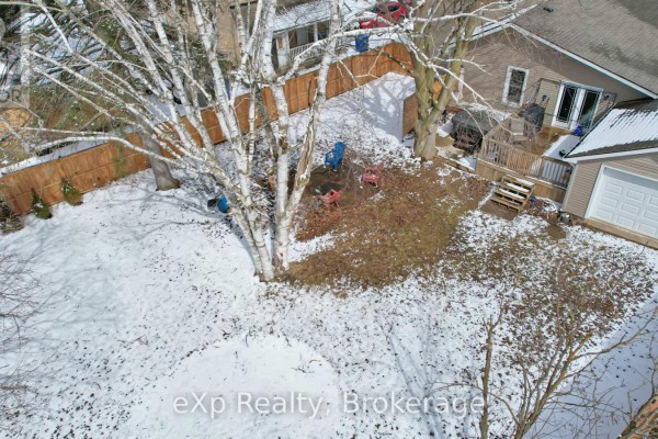Snowy backyard with deck, garage, and patio chairs - 370 6th Avenue Hanover