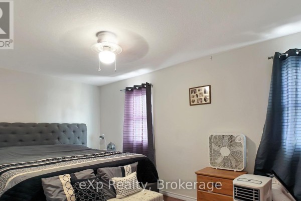 Bedroom with tufted headboard, ceiling fan, and fans - 370 6th Avenue Hanover