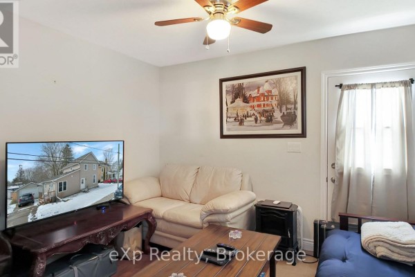 Living room with TV, sofa, futon, and ceiling fan - 370 6th Avenue Hanover
