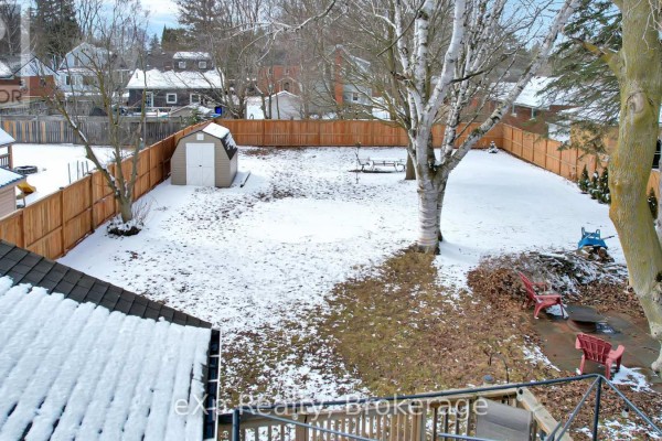 Snowy backyard with shed, playset, fire pit, chairs, and fence - 370 6th Avenue Hanover