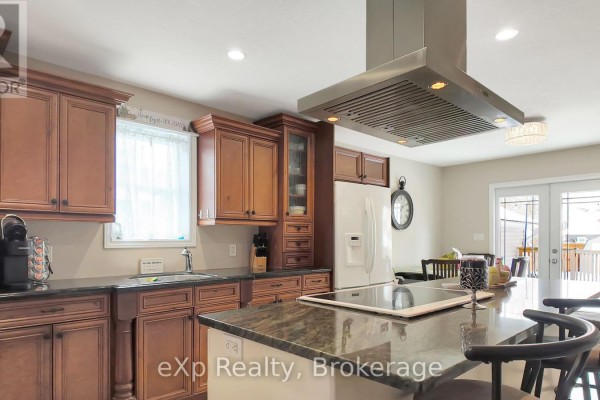 Kitchen with island cooktop and dark wood cabinets - 370 6th Avenue Hanover