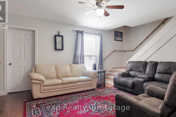 Spacious kitchen with a large island, dark wood cabinets, white cabinets, and tiled floors. - 370 6th Avenue, Hanover