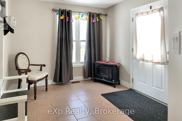Entryway with bench, hall tree, chair, and electric fireplace - 370 6th Avenue Hanover