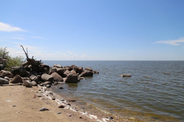 Sandy beach with large rocks and calm water under a blue sky. - 37042 Road 103 N Bay, St Clements