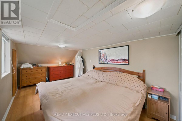 Bedroom with bed, dressers, artwork, and sloped ceiling - 3705 Champlain Street E Clarence Rockland