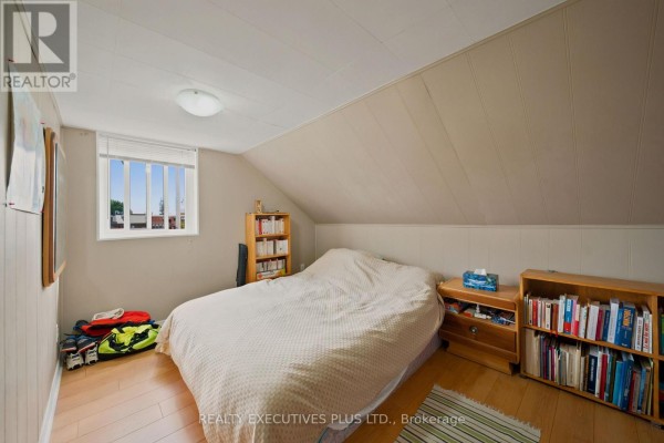 Bedroom with bed and bookshelves - 3705 Champlain Street E Clarence Rockland