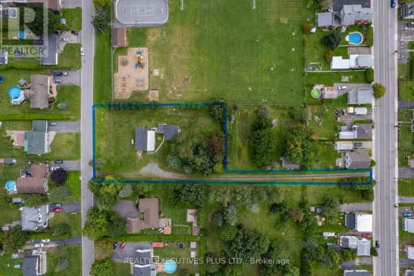 Aerial view of houses, playground, sports field, and pool - 3705 Champlain Street E Clarence Rockland