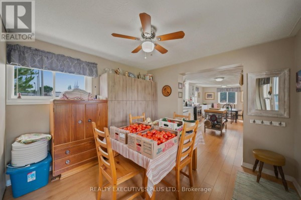 Dining area with produce on a table, wooden furniture, and a view into an adjacent room. - 3705 Champlain Street E, Clarence Rockland