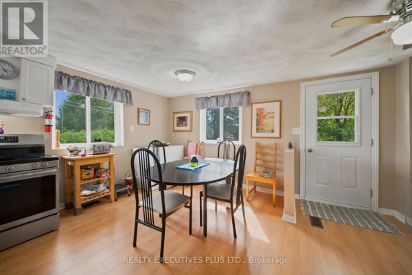 Dining room with table and chairs, kitchen appliances, and exterior door - 3705 Champlain Street E Clarence Rockland