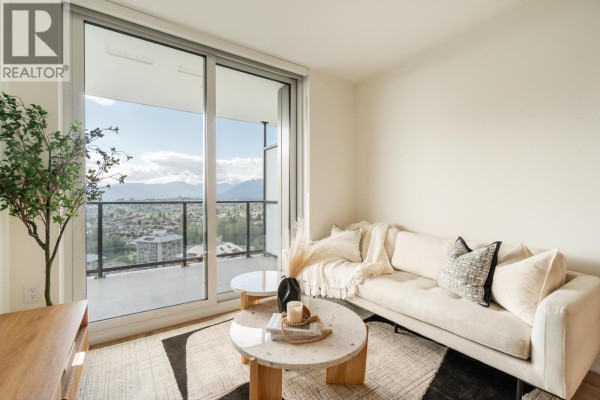 Bright living room with couch, coffee table, and expansive windows overlooking city. - 3707 2135 Springer Avenue, Burnaby