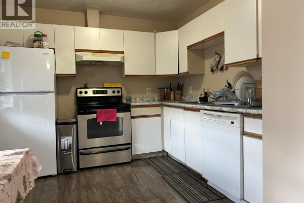 Kitchen with white cabinets, stainless steel refrigerator, stove, and dishwasher. - 3710 24 Avenue Unit# 202, Vernon