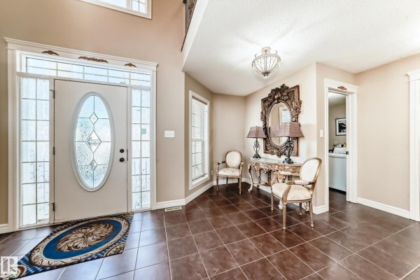 Entryway with tile flooring, chandelier, and decorative furniture - 3711 163 Av Nw, Edmonton