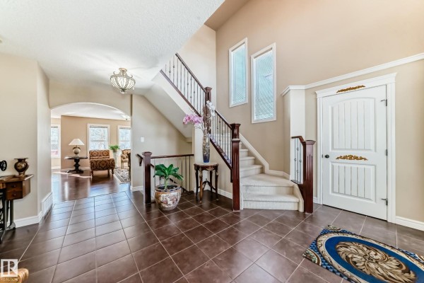 View of the foyer showing staircase, seating area, and natural light - 3711 163 Av Nw, Edmonton