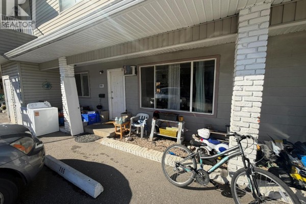 Another angle of the townhouse exterior unit 108, showcasing bicycles and outdoor items. - 3712 24 Avenue Unit# 108, Vernon