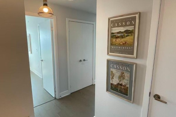 Spacious building lobby with marble columns, large windows, and tiled floors. - 3721 - 30 Shore Breeze Drive, Toronto