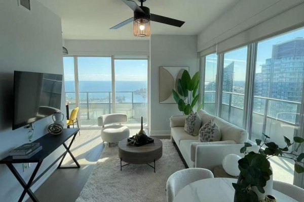 Well-equipped gym with cardio machines, free weights, and mirrored walls. - 3721 - 30 Shore Breeze Drive, Toronto
