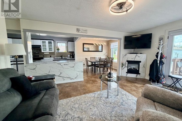 Open concept living room, dining room, and kitchen with modern finishes. - 374 Ste Helene Avenue, Iroquois Falls
