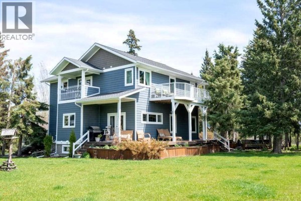 Kitchen with granite countertops, stainless steel appliances, and colorful walls, featuring a large window. - 374074 Range Road 6-2, Rural Clearwater County