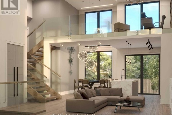 Open-concept living space with a sectional sofa, dining table, island, and a floating wooden staircase. - 3745 Sunbank Crescent, Severn