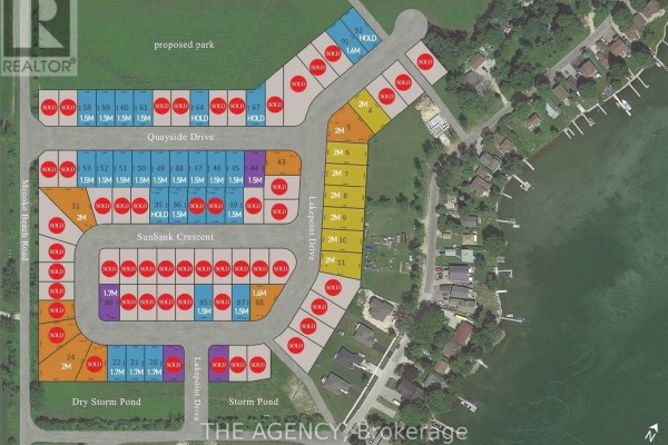 Aerial view of a suburban street with multiple lots, many marked as sold, bordering a body of water. - 3745 Sunbank Crescent, Severn