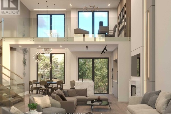 Spacious living room with a large sectional, fireplace, dining area, and upper-level loft overlooking the space. - 3745 Sunbank Crescent, Severn