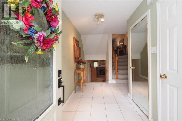 View from front door into entryway with stairs leading up to second floor. - 375 Holiday Inn Drive Unit# 34, Cambridge