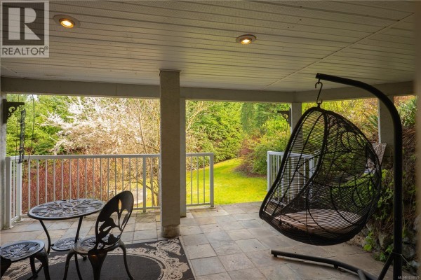 A half bathroom with a pedestal sink, toilet, and wooden floors. - 3758 Panorama Cres, Chemainus