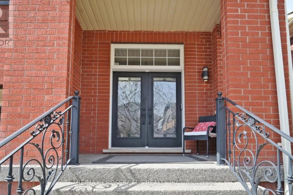 Close-up of a dark brown garage door on a red brick house. - 378 Malboeuf Court, Milton