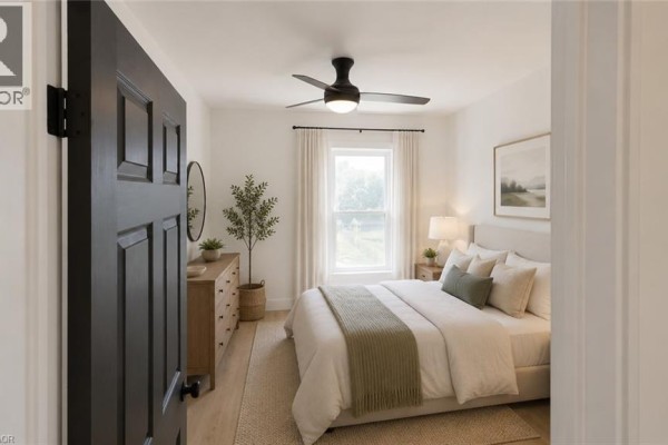 Bedroom with queen bed, nightstands, dresser, ceiling fan, and window with curtains. - 379 Main Street Unit# 3, Woodstock