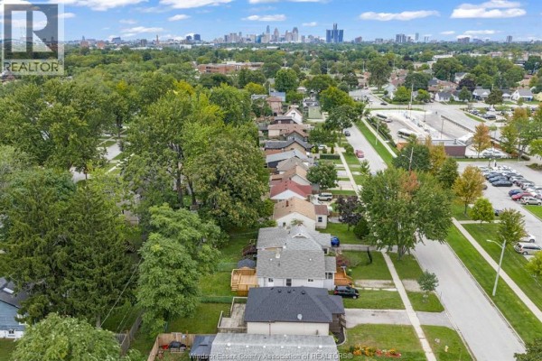 Aerial view of residential street with subject property in foreground and city skyline. - 3796 Glenfield Street, Windsor