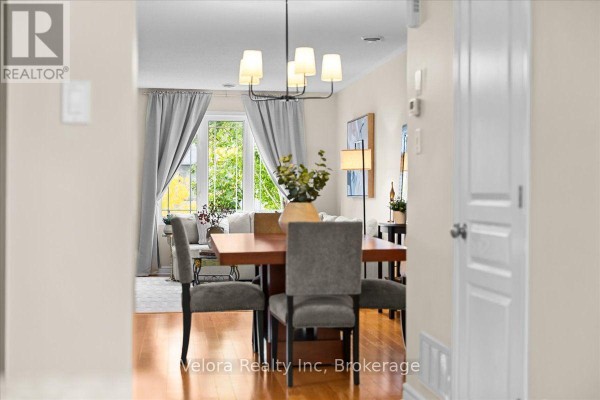 View from dining room to living room with large windows and grey curtains. - 494 Leboutillier Avenue, Ottawa