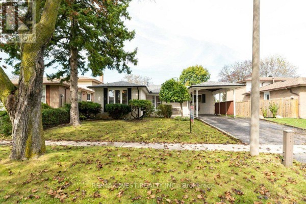 Front view of the house from the lawn, showing mature trees. - 38 Albacore Crescent, Toronto