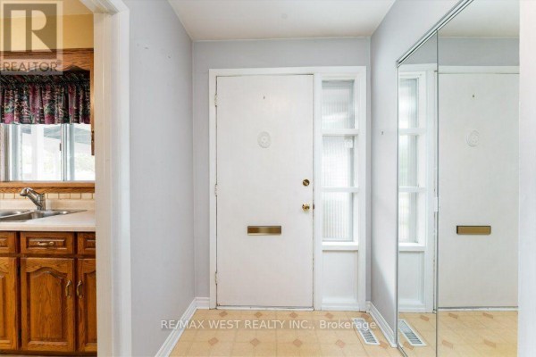 Interior front foyer with a white door, mirrored closet, and light-colored floor. - 38 Albacore Crescent, Toronto