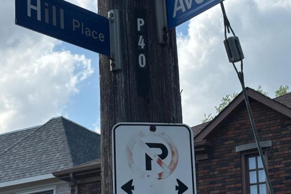 Street signs for Avenal Drive and Hill Place on a wooden pole with a no U-turn sign. - 38 Avenal Drive, Toronto