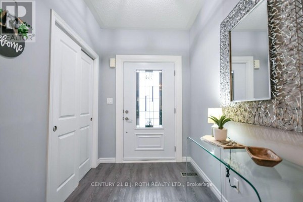 Interior foyer with a glass console table and large decorative mirror. - 38 Beverly Street, Springwater