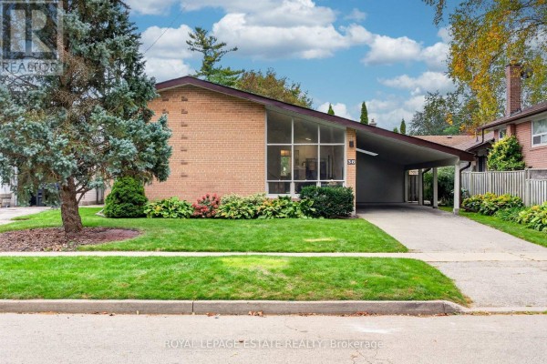 Side view of the residential property at 38 Brightside Drive showing the lawn and carport. - 38 Brightside Drive, Toronto