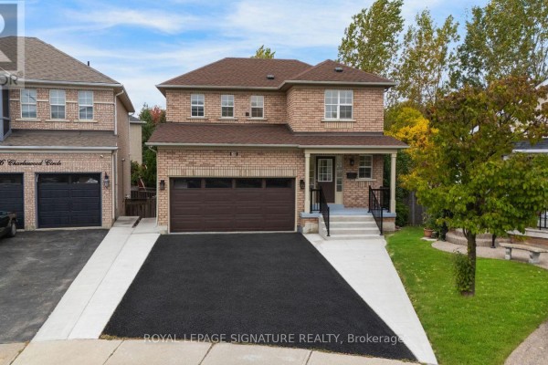 Front exterior view of the house showing the brick facade, garage, and front entrance. - 38 Charleswood Circle, Brampton