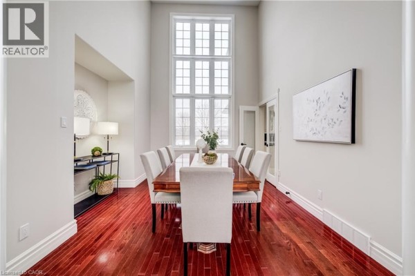 View of the dining area from the side, highlighting the table and decor - 38 Deer Ridge Crescent, Kitchener