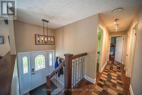 Interior view of the entryway showing the front door, staircase, and hallway. - 38 Duchesse Crescent, Russell