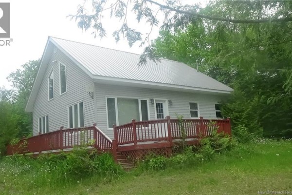 Screened-in porch with wicker chairs, a swing, and a view of a grassy yard. - 38 Farrell Lane, North Lake