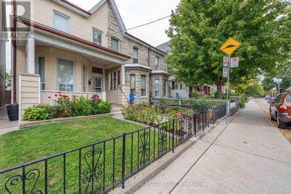 Street view of residential homes on Gordon Street, Toronto, with sidewalks, parked cars, and trees. - 38 Gordon Street, Toronto