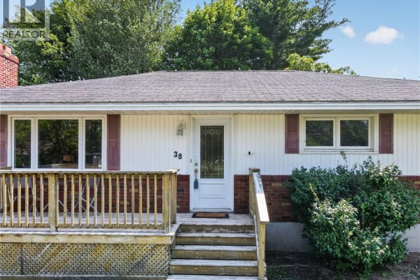 Close-up of the front entrance featuring a white door with glass panels and a wooden deck. - 38 Lindsay Street, Riverview