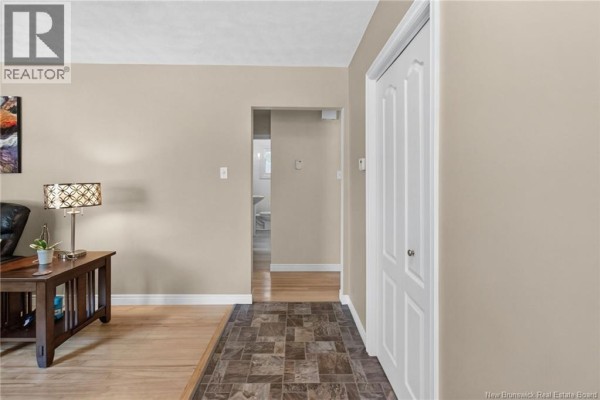 View from the entryway into the living area, showing wood floors, a hallway, and a closet. - 38 Lindsay Street, Riverview