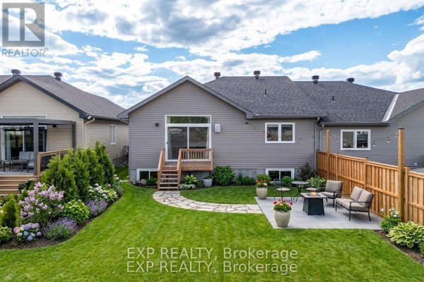 Exterior view of a modern detached house with stone and vinyl siding and a garage. - 38 Yade Road, Arnprior