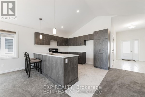 A bright bedroom with grey carpet, white walls, and a coffered ceiling with a window. - 38 Yade Road, Arnprior