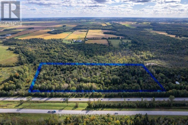 Aerial shot showing marked land surrounded by trees, near a busy highway. - 380 Concession 1 Road, East Hawkesbury