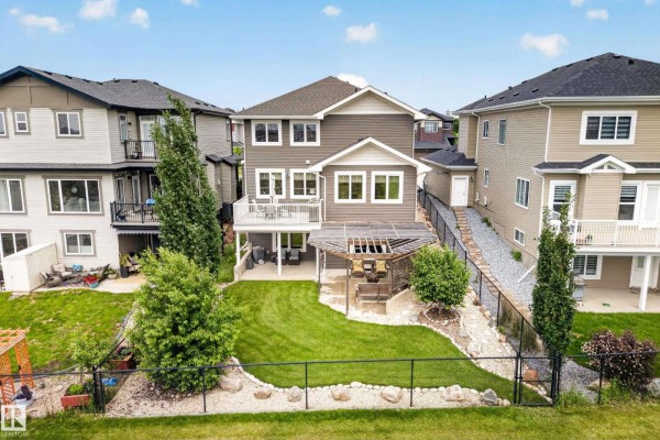 Aerial view of the front of a house with a concrete driveway and mature landscaping. - 3803 48 Av, Beaumont