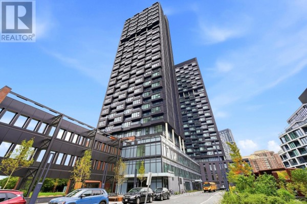 Exterior view of the modern apartment building with dark facade and glass balconies. - 3807 - 1 Quarrington Lane, Toronto