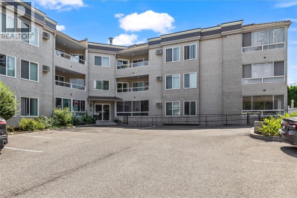 View of Leisure Terrace building entrance and surrounding parking area. - 3815 Brown Road Unit# 107, West Kelowna