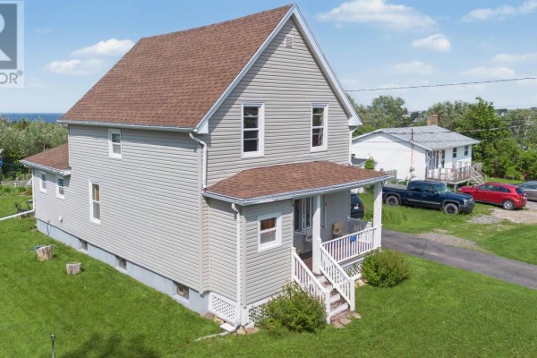 Exterior side view of the house, showing the main structure and an attached section. - 383 Kings Road, Dominion